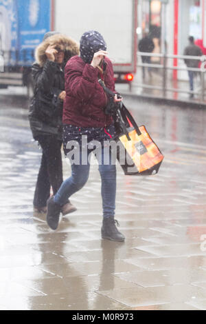 London UK. 24th January 2018. Pedestrians and shoppers are caught in heavy downpours and freezing rain in Wimbledon town centre brought about by Storm Georgina Credit: amer ghazzal/Alamy Live News Stock Photo