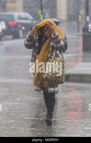 London UK. 24th January 2018. Pedestrians get a soaking in heavy downpours and freezing rain in Wimbledon town centre brought about by Storm Georgina Credit: amer ghazzal/Alamy Live News Stock Photo
