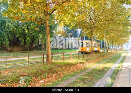 Milan tramway in perspective during autumn season. Traditional transportation mode. Urban panorama. Stock Photo