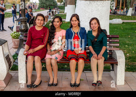 A Group Of Young Uzbek Women Sitting On A Bench, Samarkand, Uzbekistan Stock Photo