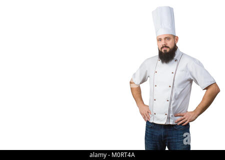 Portrait of handsome serious bearded male chef in uniform hands on waist isolated on white background, copy space on side. Stock Photo