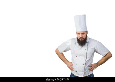 Portrait of handsome evil bearded male chef in uniform hands on waist isolated on white background, copy space on side. Stock Photo