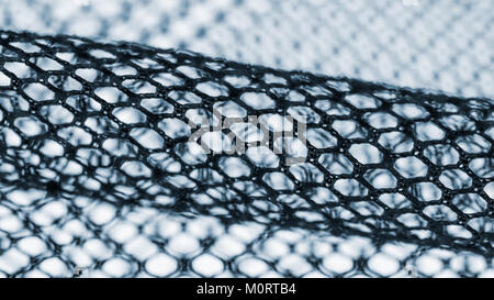 Abstract texture from netting with diagonal strip on blurred background. Artistic detail of hexagonal cells. Symbolize science, research, technology. Stock Photo