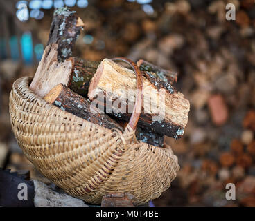Basket with firewood with selective focus outdoor Stock Photo