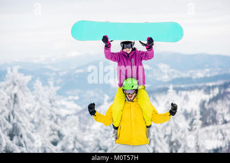 Couple in sports clothes during the winter vacation on the mountains Stock Photo