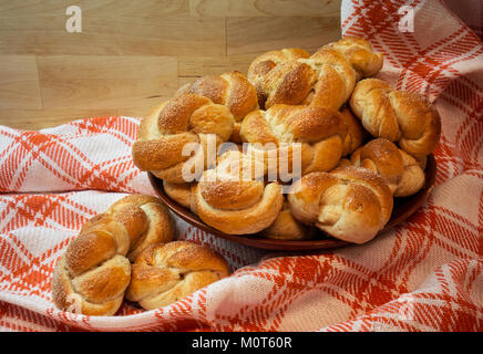Cardamom buns are a traditional Swedish pastry, often enjoyed with coffee. Known for their fragrant blend of cardamom and sweet dough, they are a popular treat in Scandinavian countries, particularly during festive occasions. Stock Photo