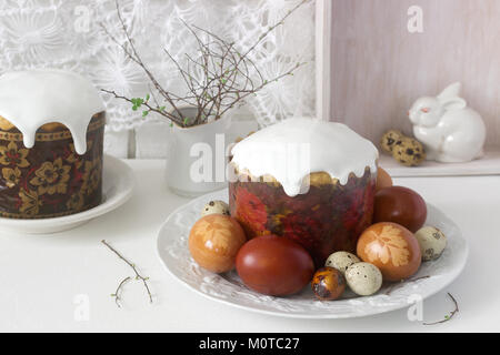 Easter still life with Easter cake kulich and painted eggs on a light background. Stock Photo