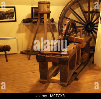 Photograph of a carpenter's workshop featuring tools, workbenches, and wood materials. The space is set up for woodworking tasks such as cutting, shaping, and assembling wood products. Stock Photo