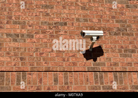 This image shows a brick wall with CCTV cameras mounted, symbolizing surveillance and security measures often used in urban areas for safety and monitoring purposes. Stock Photo