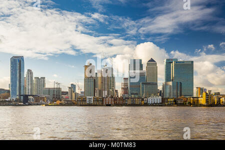 Modern skyscrapers of Canary Wharf with old riverfront houses and Thames in foreground, January 2018, Greenwich London Stock Photo