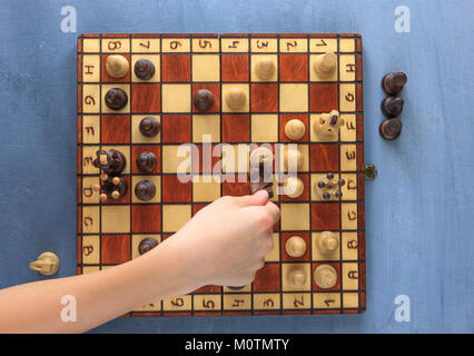 An overview of a chess player taking out a knight. Stock Photo