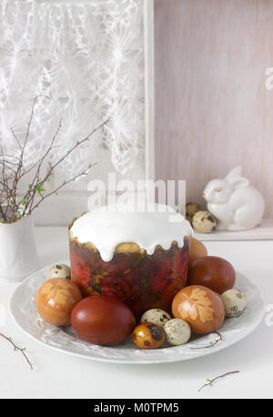 Easter still life with Easter cake kulich and painted eggs on a light background. Stock Photo