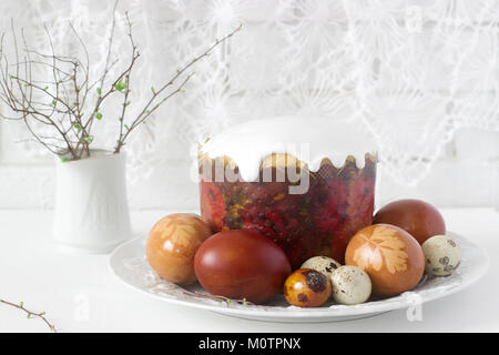 Easter still life with Easter cake kulich and painted eggs on a light background. Stock Photo