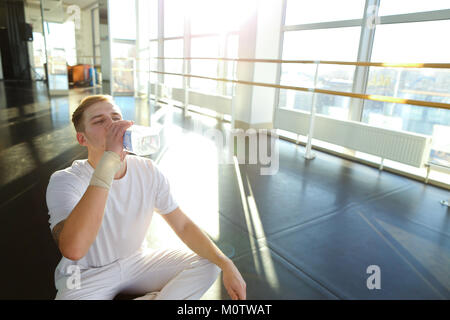 Guy doing drinking water before morning training.  Stock Photo