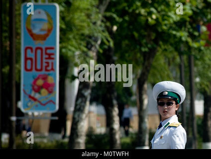 North Korean female traffic security officer in white uniform in the street, Pyongan Province, Pyongyang, North Korea Stock Photo