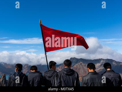 Group of students with red flag in front of lake at mount Paektu, Ryanggang Province, Mount Paektu, North Korea Stock Photo