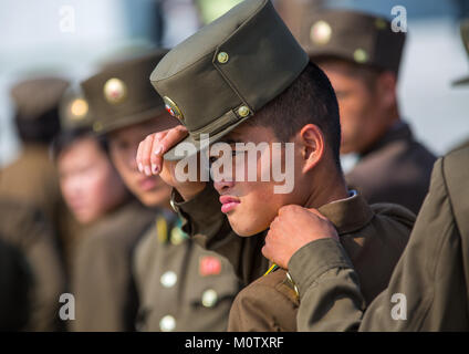 North Korean soldier putting his kepi, Pyongan Province, Pyongyang, North Korea Stock Photo
