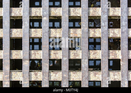 Close-up view of a solid cast iron grid with surface rust. Stock Photo
