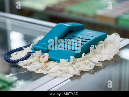 An old blue fashioned telephone on a dresser in Yanggakdo international hotel, Pyongan Province, Pyongyang, North Korea Stock Photo