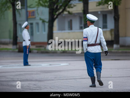 North Korean male traffic security officers in white uniforms in the street, North Hwanghae Province, Kaesong, North Korea Stock Photo