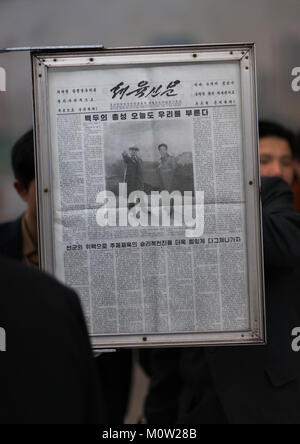 North Korean people reading the offical state newspaper in a metro station, Pyongan Province, Pyongyang, North Korea Stock Photo