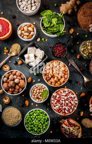 Set of organic healthy diet food, superfoods - beans, legumes, nuts, seeds, greens, fruit and vegetables. Dark blue background copy space top view Stock Photo