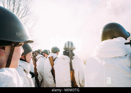 Rogachev, Belarus - February 25, 2017: Re-enactors Dressed As Russian Soviet Infantry Soldiers Of World War II Standing In Row. People Dressed In Whit Stock Photo