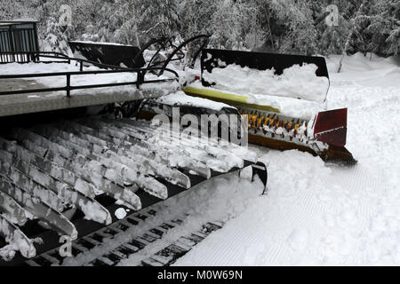 Ratrac. Ratrack, snow grooming machine prepares slopes for skiers on a ski resort in mountains. Ratrac machine for skiing slope preparations in the mo Stock Photo