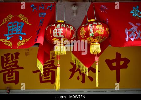 Red and gold lanterns with banners celebrating Chinese Lunar New Year in Geylang, Singapore Stock Photo