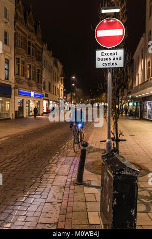 No Entry sign at a pedestrian shopping zone road at night in Worthing, West Sussex, England, UK. Stock Photo