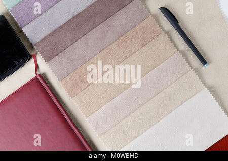 Bright collection of colorful textile samples with suede texture. Mockup with fabric samples, smartphone and wallet. Stock Photo