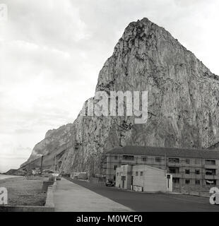 1950s, historical picture showing the famous 'Rock of Gibraltar', a 426m-high limestone ridge formed in the jurassic age. A headland on Spain's south coast, Gibraltar has been a British Overseas Territory since 1713 when it was ceded by Spain. Stock Photo