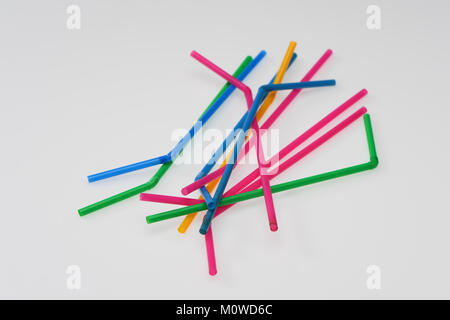 A range of coloured drinking straws on a white background. Stock Photo