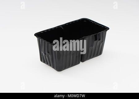 A black single use plastic food container ready for recycling on a white background. Stock Photo