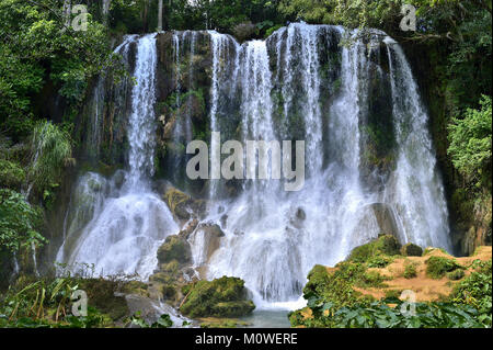 Waterfall in a lush rainforest. Beautiful waterfalls or cascades in El Nicho, El Nicho waterfall, in Scambray mountains. Cienfuegos province, Cuba. Stock Photo