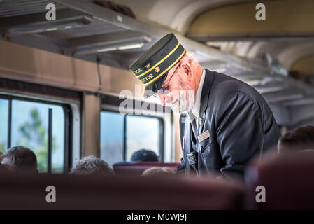 Summerland, British Columbia/Canada - the conductor takes tickets from passengers on the Kettle Valley Steam Railway. Stock Photo