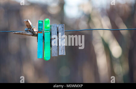 Old hooks for laundry on wire Stock Photo