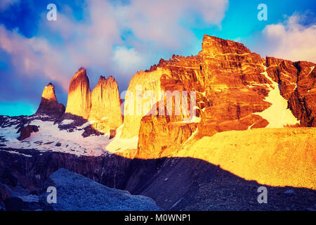 Torres del Paine famous rock formations at pink sunrise, color toned picture, Patagonia, Chile. Stock Photo