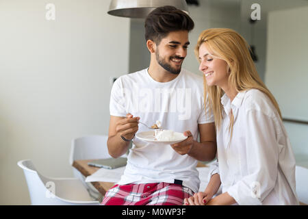 Cute young cheerful couple spending time at home Stock Photo