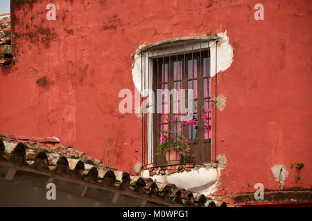 Rustic old window on a red wall, Mexico Stock Photo