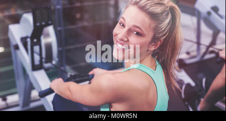 Fit woman on drawing machine Stock Photo