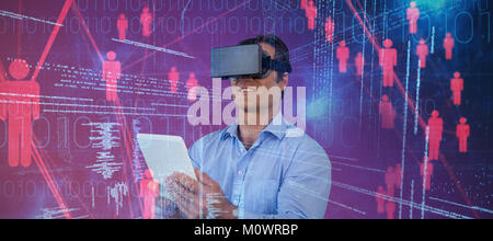 Composite image of businessman with tablet sitting on chair while using vr glasses Stock Photo