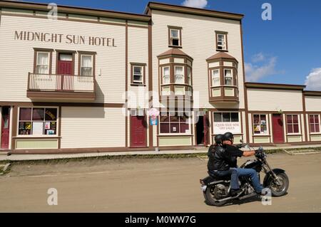 Canada,Yukon Territory,Dawson City,Midnight Sun Hotel,Biker On The Street Stock Photo