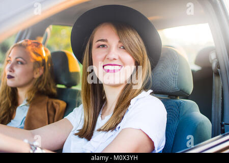 Two girl friends taking a road trip by car Stock Photo