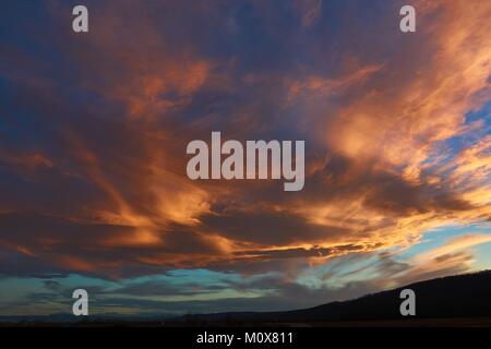 Orange sunset on the background mountains, in the foothills of the North Caucasus Stock Photo