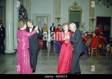 Washington, DC - (FILE) -- United States President Ronald Reagan and Prime Minister Margaret Thatcher of Great Britain share a dance in the Entrance Hall of the the White House in Washington, D.C. following the dinner in her honor on Wednesday, November 16, 1988.  At right their spouses, first lady Nancy Reagan and Denis Thatcher share a dance as well..Credit: Ron Sachs / CNP/ MediaPunch Stock Photo