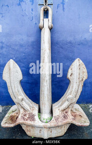 Large anchor leaning of a wall. Stock Photo