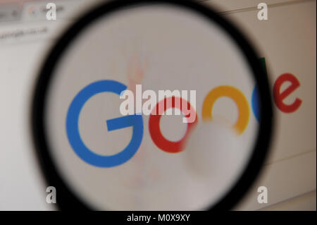 The Google logo seen through a magnifying glass Stock Photo