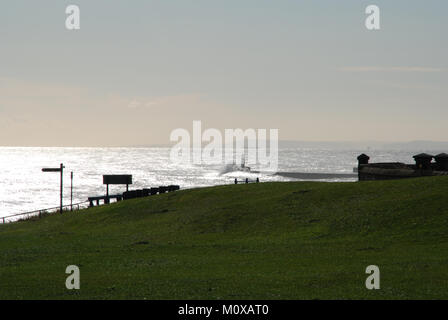 Seaham Harbour lighthouse and pier from clifftop with waves breaking over the pier Stock Photo