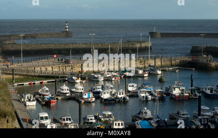 The marina at Seaham Harbour in County Durham showing the harbour and marina entrance and the small boats and yachts in the marina Stock Photo